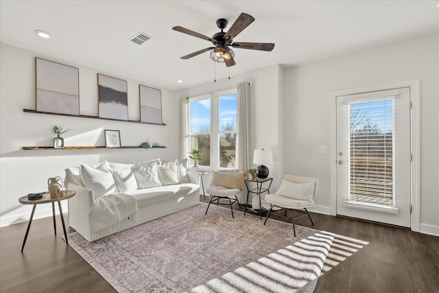 living room featuring hardwood / wood-style flooring and ceiling fan