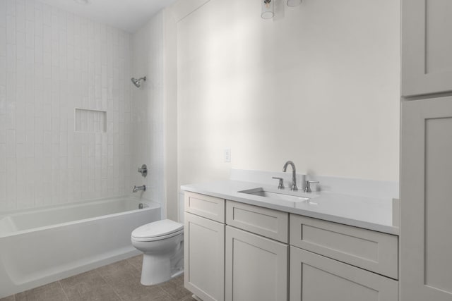 full bathroom with tile patterned flooring, toilet, vanity, and tiled shower / bath