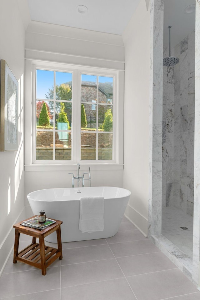 bathroom featuring tile patterned flooring and plus walk in shower