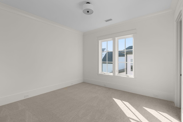 carpeted empty room with a water view and ornamental molding