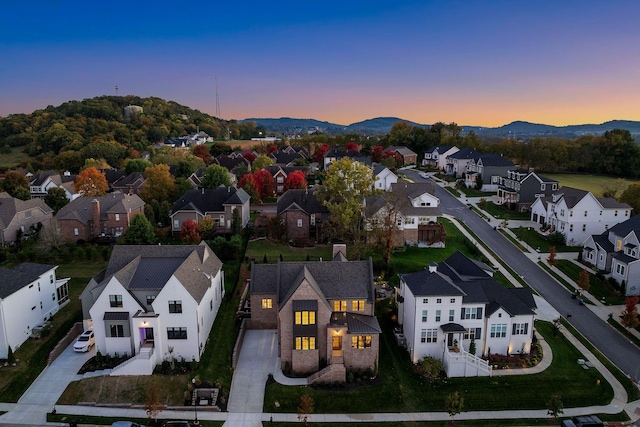 aerial view at dusk featuring a mountain view