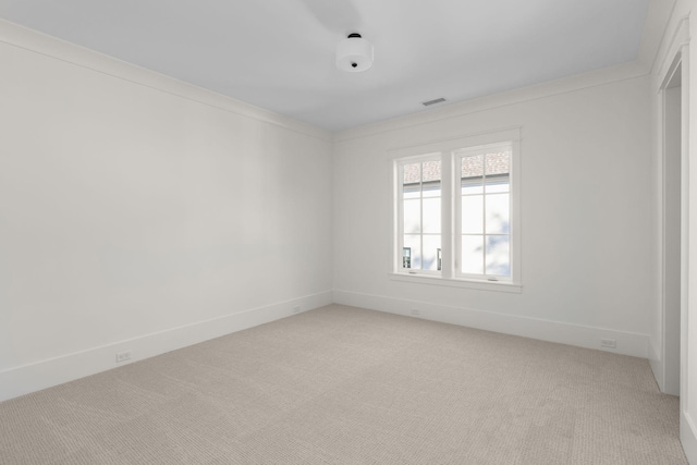 carpeted empty room with crown molding