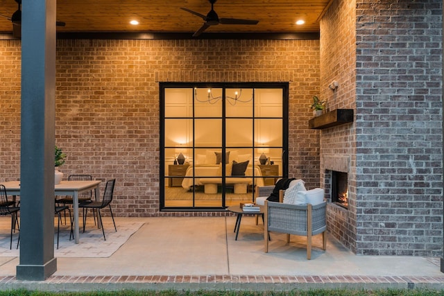 view of patio / terrace featuring an outdoor brick fireplace