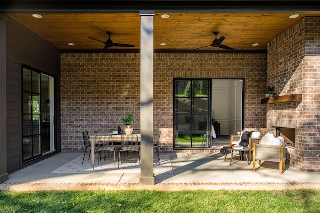 view of patio / terrace featuring ceiling fan and an outdoor brick fireplace