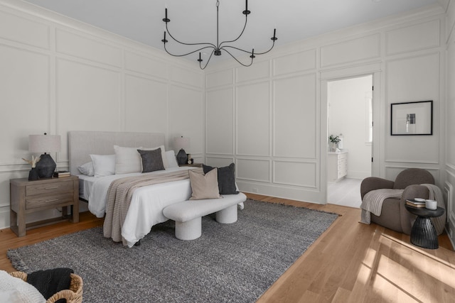 bedroom featuring hardwood / wood-style floors and a notable chandelier