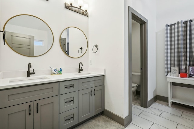 bathroom featuring vanity and toilet