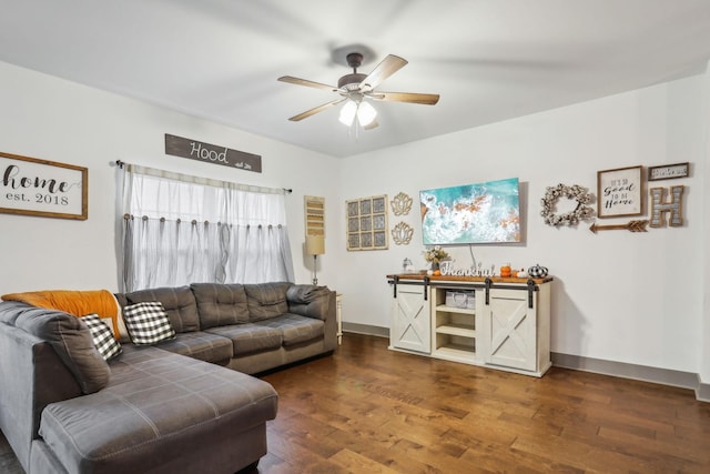 living room featuring ceiling fan and dark wood-type flooring