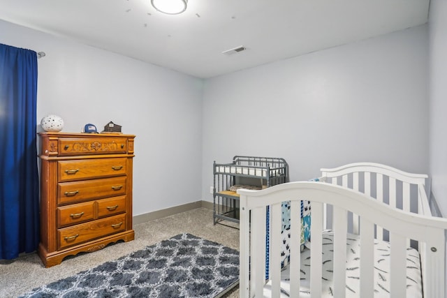 bedroom featuring a nursery area