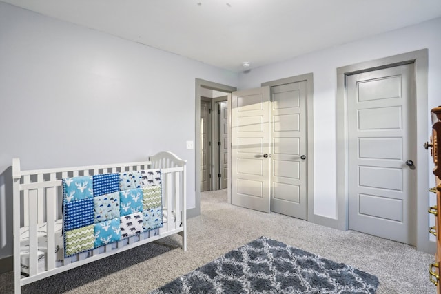 bedroom with carpet and a crib