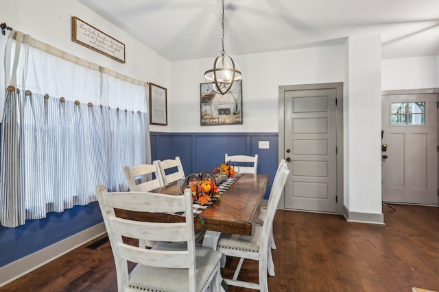 dining space featuring a notable chandelier and dark wood-type flooring