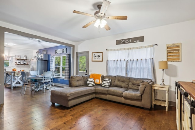 living room with dark hardwood / wood-style flooring and ceiling fan