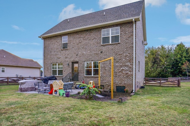 rear view of house with a yard and a patio