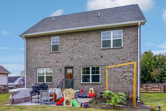 rear view of house featuring a yard and a patio area