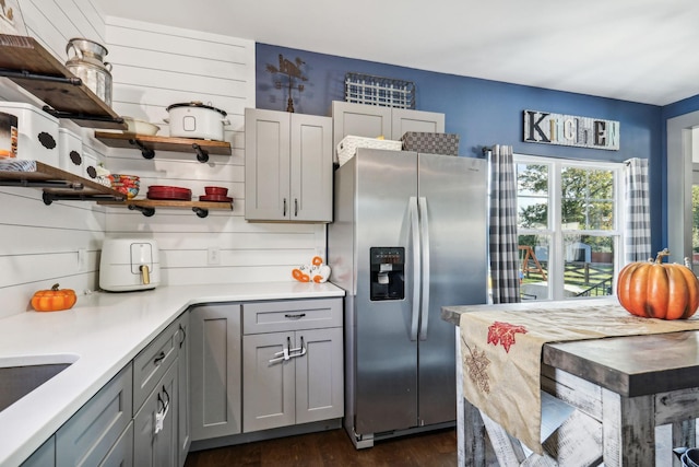 kitchen with dark wood-type flooring, sink, gray cabinets, tasteful backsplash, and stainless steel fridge with ice dispenser