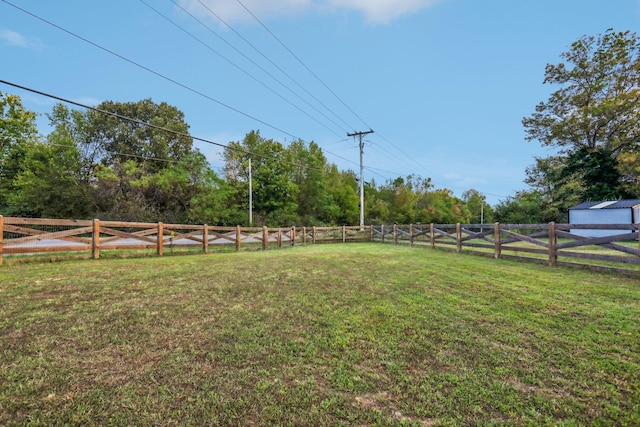 view of yard with a rural view