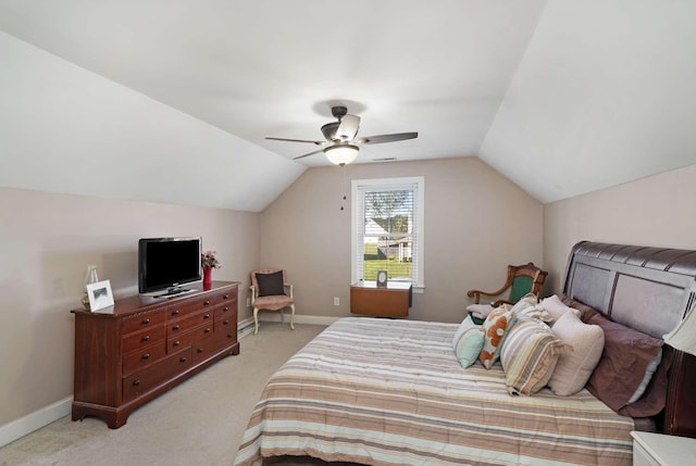 bedroom featuring ceiling fan, lofted ceiling, and light carpet