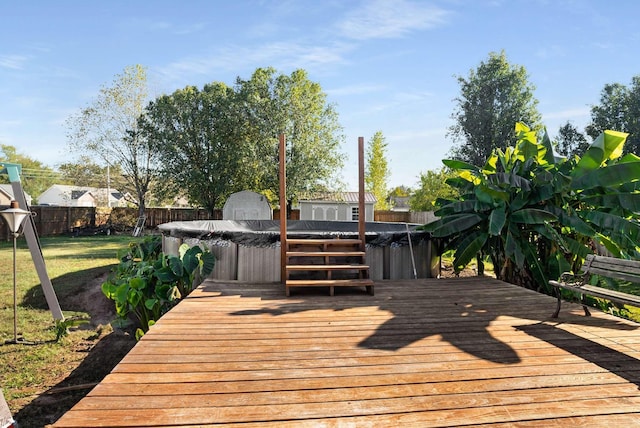 wooden deck with a hot tub