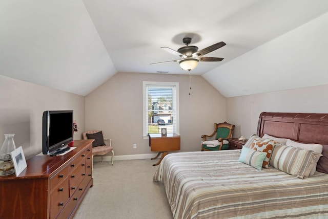 bedroom featuring light colored carpet, vaulted ceiling, and ceiling fan