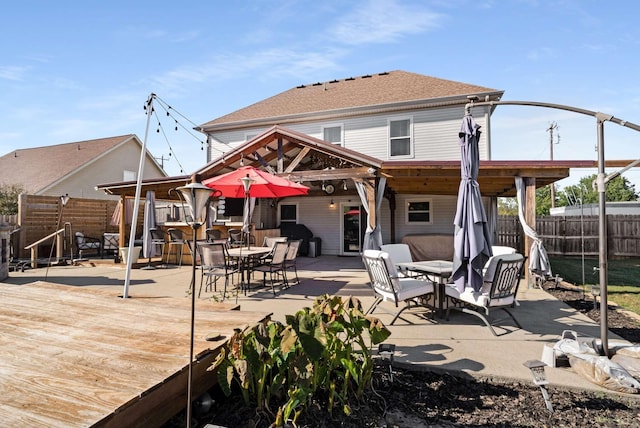 back of house featuring an outdoor bar and a wooden deck