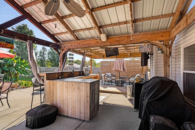 view of patio / terrace with a gazebo, ceiling fan, a grill, and a bar