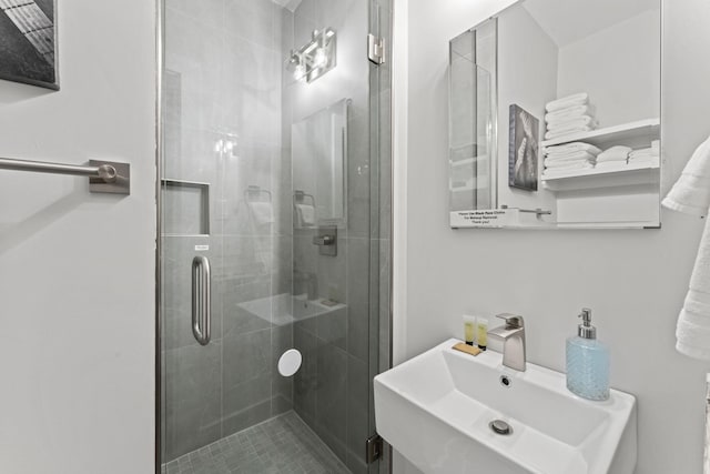 bathroom with sink and an enclosed shower