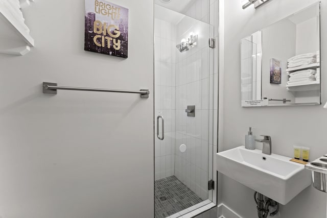 bathroom featuring sink and a shower with shower door