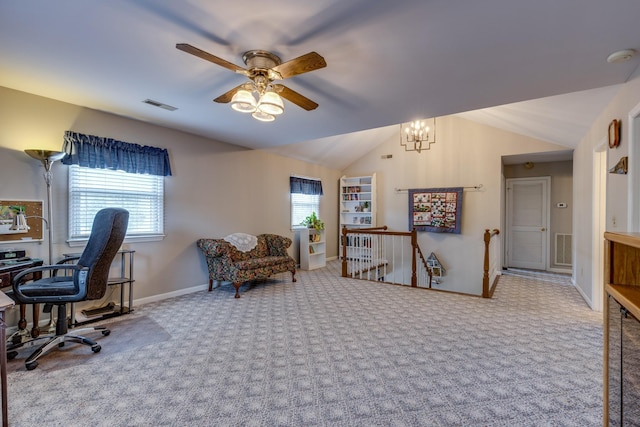 home office featuring ceiling fan with notable chandelier, carpet flooring, and vaulted ceiling