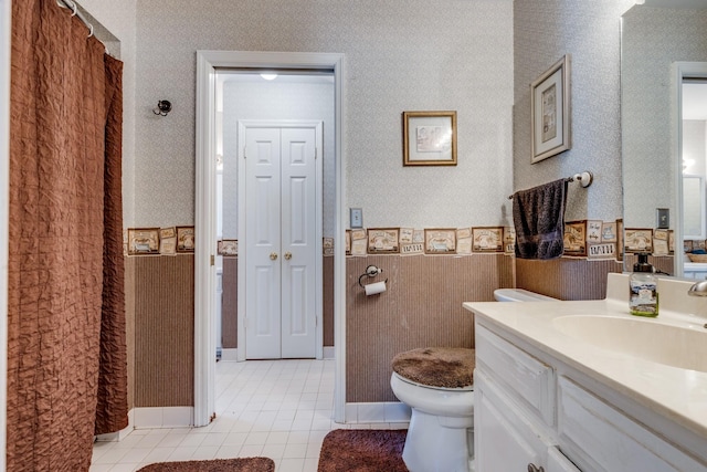 bathroom with tile patterned flooring, vanity, and toilet