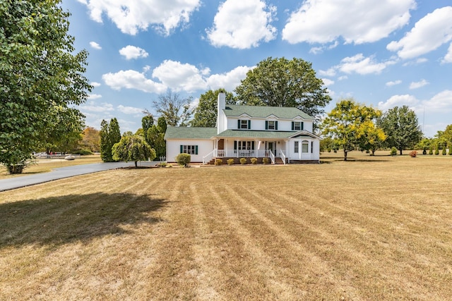 view of front facade with a front lawn and a porch