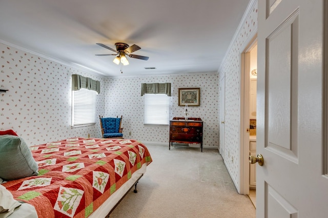 carpeted bedroom with crown molding, ceiling fan, and ensuite bathroom