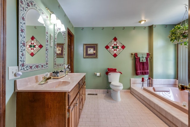 bathroom featuring vanity, toilet, tile patterned flooring, and tiled tub