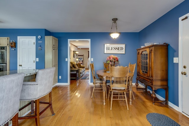 dining space with light wood-type flooring