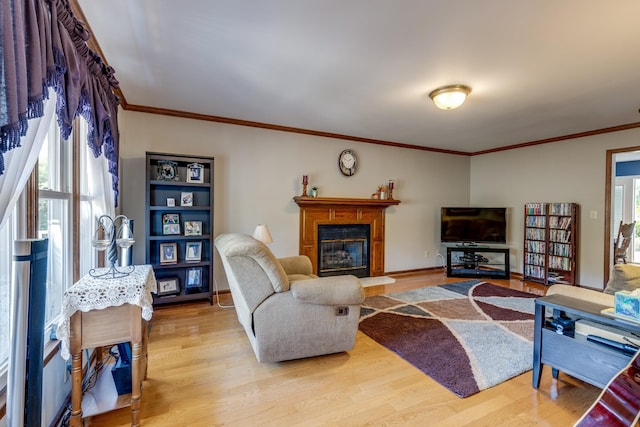 living room featuring ornamental molding, a wealth of natural light, and light wood-type flooring