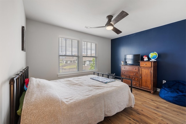 bedroom featuring light hardwood / wood-style flooring and ceiling fan