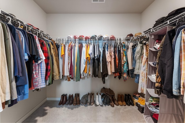 walk in closet featuring carpet flooring