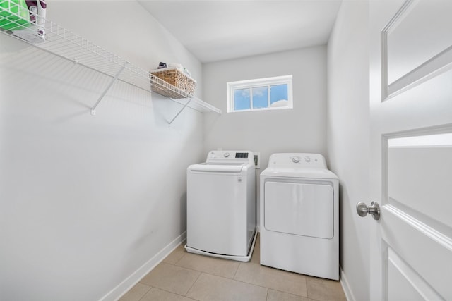 laundry room featuring light tile patterned floors and independent washer and dryer