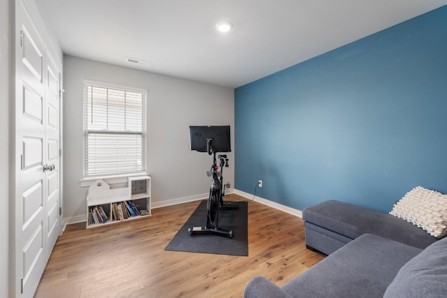 workout area with hardwood / wood-style floors