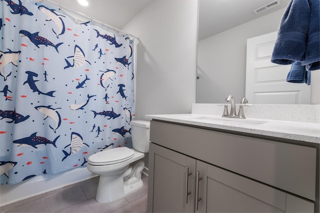 bathroom featuring tile patterned flooring, vanity, and toilet