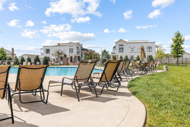 view of pool featuring a patio area and a lawn