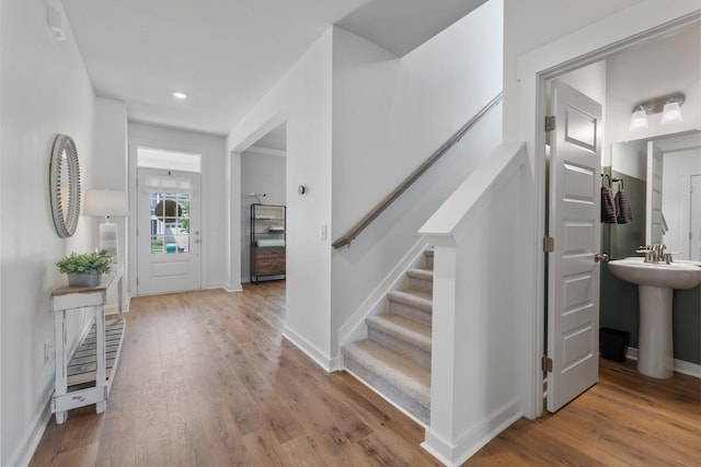 entrance foyer featuring light wood-type flooring and sink