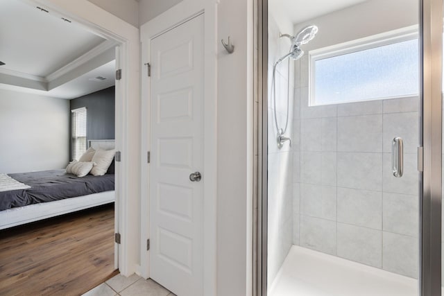 bathroom with crown molding, tile patterned flooring, plenty of natural light, and walk in shower