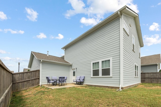 back of house featuring a patio area and a yard