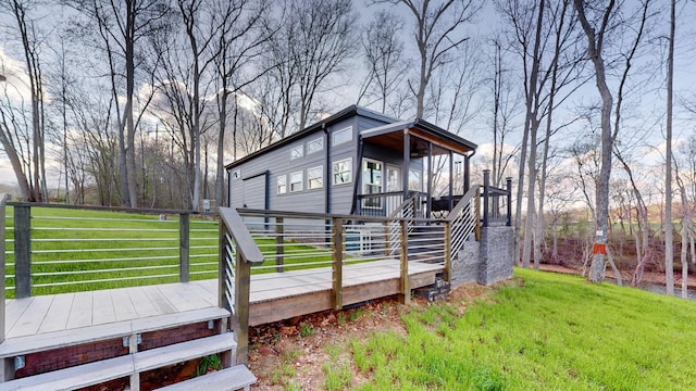 view of side of property with a yard and a deck