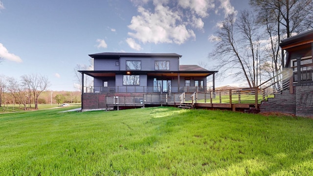 back of property with a yard and a wooden deck