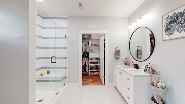 bathroom featuring vanity and an enclosed shower