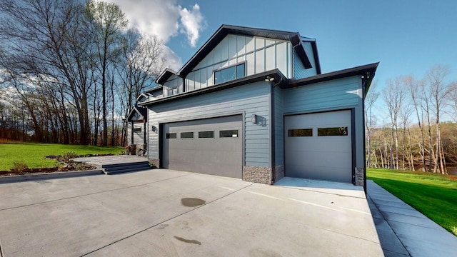 view of side of property with a yard and a garage