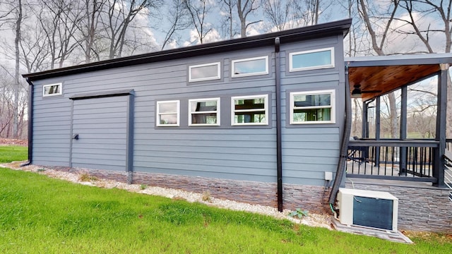 view of side of home with ac unit