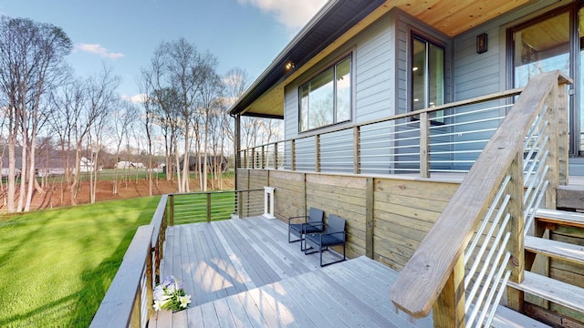 wooden deck featuring a yard