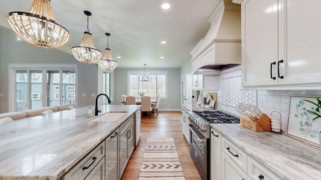 kitchen with white cabinets, a spacious island, sink, and appliances with stainless steel finishes