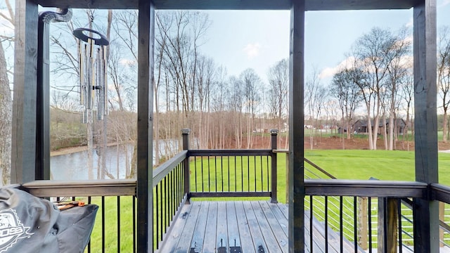 wooden terrace featuring a lawn